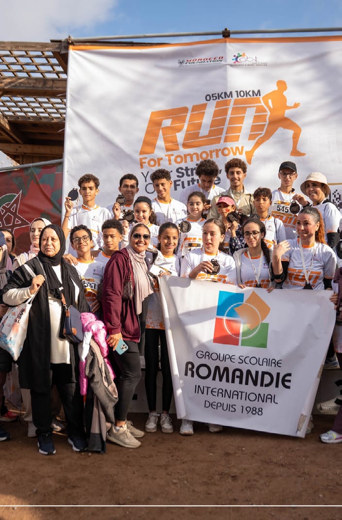 Pupils from Groupe Scolaire Romandie gathered behind their banner at the finish